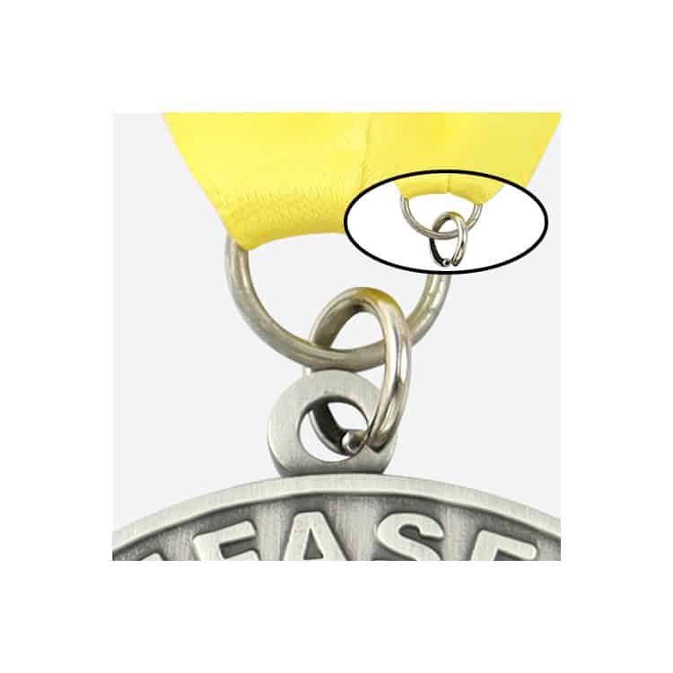 Bright yellow ribbon medal with close-up on the safety pin clasp detail, showcasing custom award medals manufacturing.