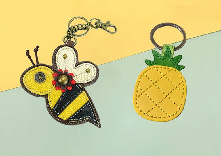 Colorful handcrafted bee and pineapple-themed keychains made from synthetic leather, ideal for promotional gifts, awards, or personalized accessories, showcasing custom embroidery and vibrant design.