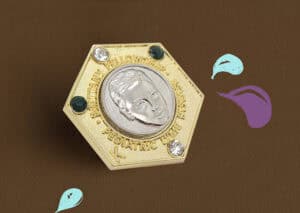 Metal sports award trophy with engraved athlete's profile and decorative gemstones, ideal for commemorating achievements and awards.
