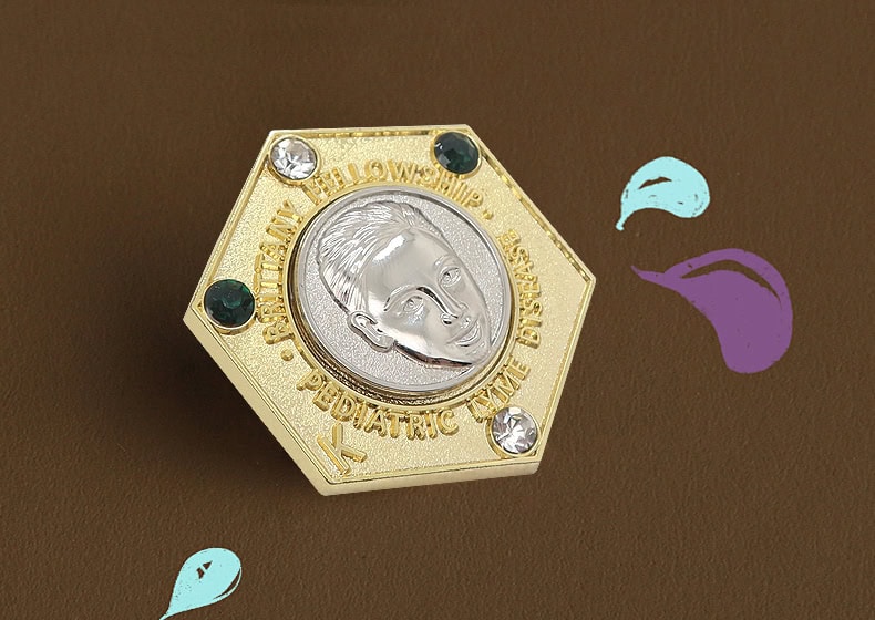 Metal sports award trophy with engraved athlete's profile and decorative gemstones, ideal for commemorating achievements and awards.