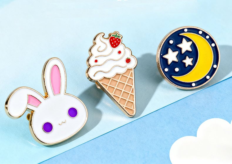 Cute bunny, ice cream cone, and moon and star themed enamel pins for custom promotional products, trophies, and medals, perfect for awards and personalized gifts from TriumphGifts.