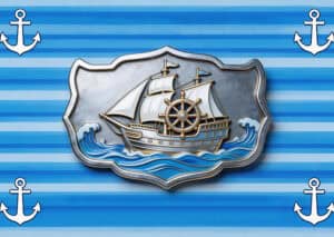 Detailed metal ship badge with nautical design on blue striped background, ideal for branding and promotional purposes.