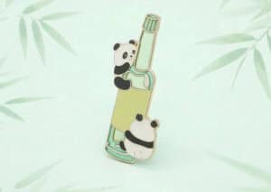 A cute panda-shaped lip balm holder with a transparent tube and a panda figure clinging to it, designed for promotional use or personal gifting.